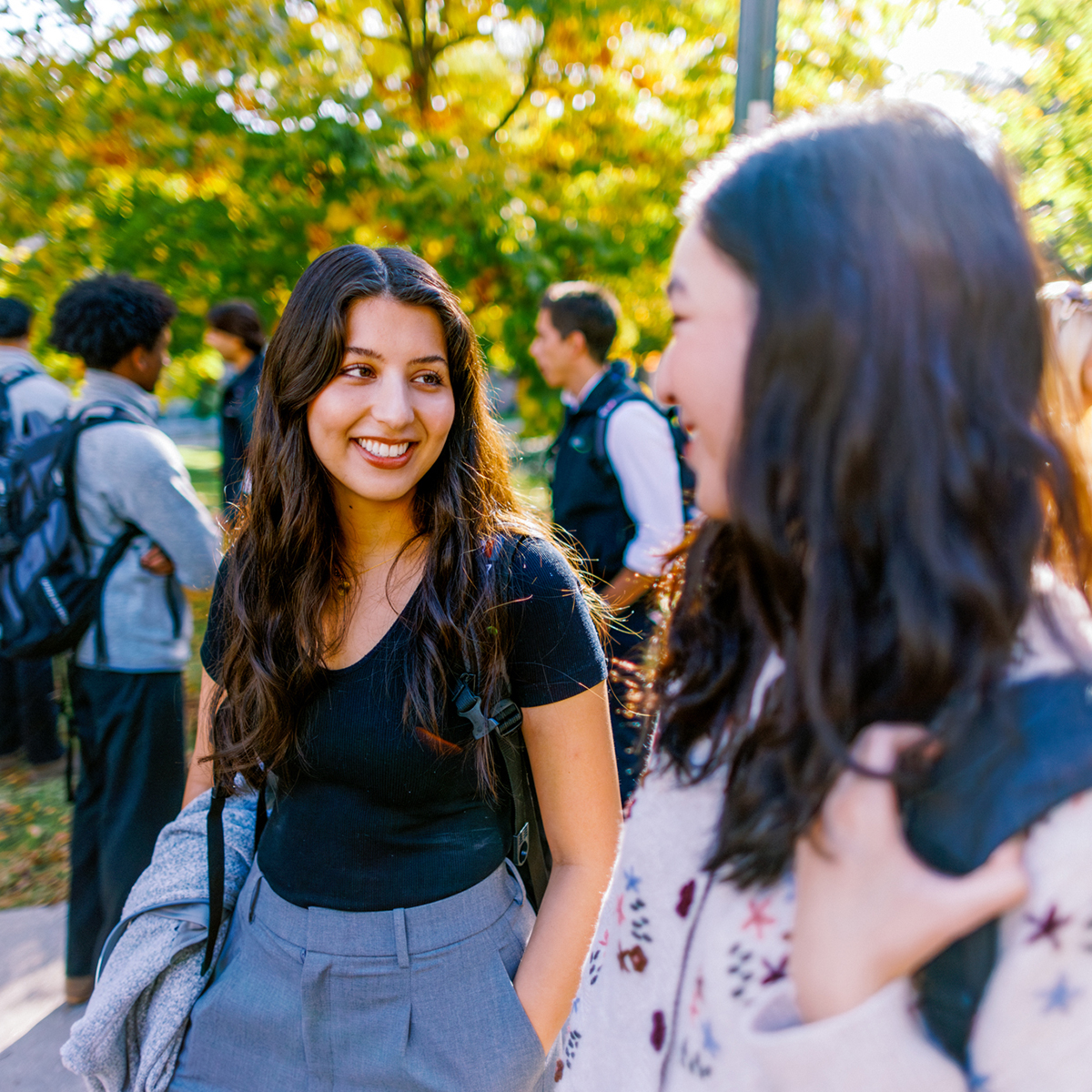 Students outdoors talking on campus